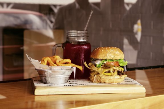 Serving of burger with fries.