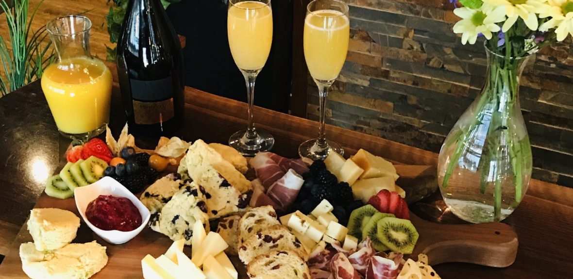 brunch with mimosas, scones fruit and cheese