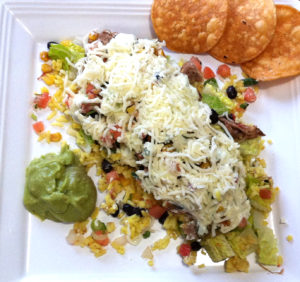 Burrito bowl with cheese and tortilla chips