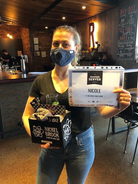 Winner Nicole holding prize pack and winner certificate
