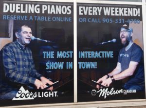2 men on 2 pianos; ad for Dueling Pianos