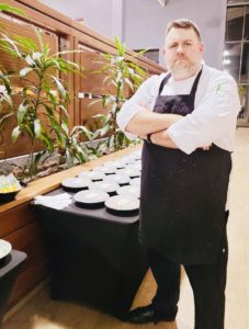 Chef Rene standing with arms crossed